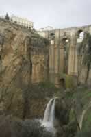 Ronda New Bridge with waterfall in The River Rio Guadalevin below