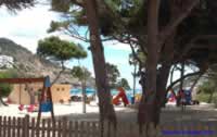 Children's playground at the rear of Cala Llonga with a beach bar for the grown ups